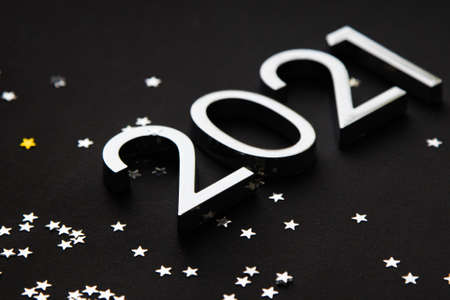 silver metal numbers 2021 and stars on black background.の写真素材
