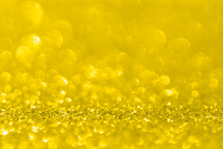 Abstract gold background with copy space. Glitter and bokeh. Christmas and new year concept. Color 2021 illuminating and Ultimate Grayの写真素材