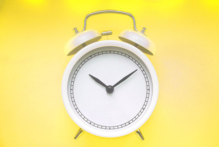 alarm clock yellow in the bedroom. Color 2021 illuminating and Ultimate Gray