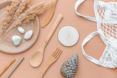 eco friendly disposable dishes made paper on white marble background. Draped spoons, fork, knives, plate with paper cups. recycling conceptの写真素材