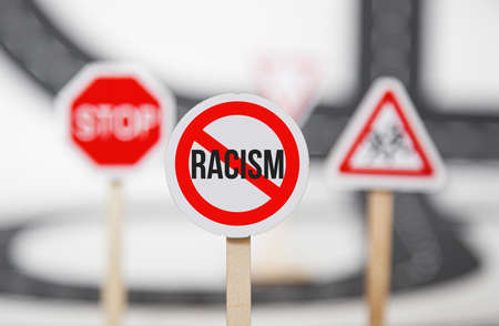 red stop sign. no racism, stop discrimination based on race religion gender . Promotion of equal rights and equal opportunitiesの写真素材