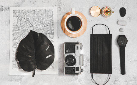 Travel  concept flat lay, Map, mask and camera on the table top viewの写真素材