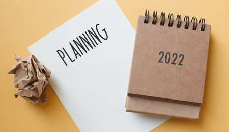 plan for 2022. Calendar , smart watch and office accessories on the table top view.の写真素材