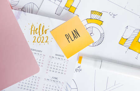 Calendar and business charts on the table top view. planning and setting goals for the next 2022 yearの写真素材