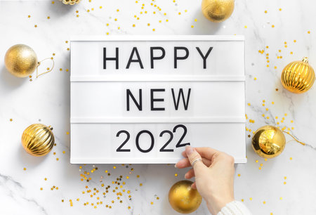 Happy new year 2022, flat lay composition on table with woman hand