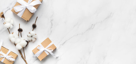 Christmas composition on white marble. Christmas gift with white ribbon, coffe cup. Top view, flat lay, copy spaceの写真素材