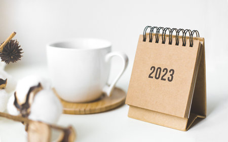 Close up calendar 2023 on table with coffe cup.の写真素材