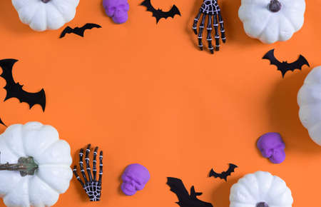 Halloween decorations bats, pumpkins and skulls on color background. Halloween concept. Flat lay, top view, copy spaceの写真素材