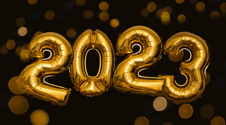 New Year 2023 golden balloons on black background with bokehの写真素材