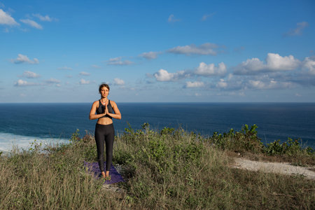 Young woman practicing yoga outdoorsの写真素材