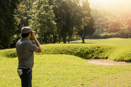 A person standing on top of a grass covered fieldの写真素材