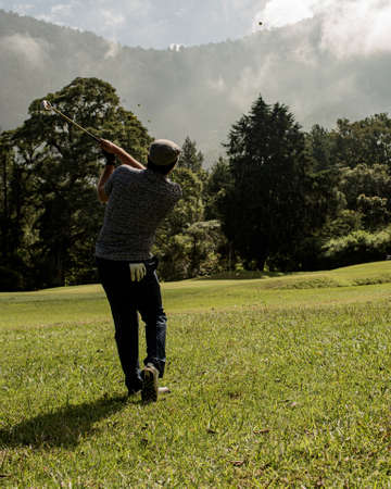 A person standing on top of a grass covered fieldの写真素材