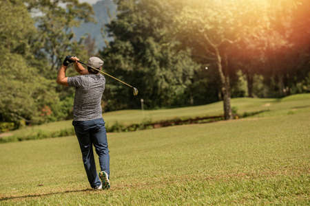 Professional golfer makes a kick on the ballの写真素材