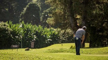 A person standing on top of a grass covered fieldの写真素材