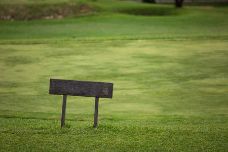 A sign on top of a lush green fieldの写真素材