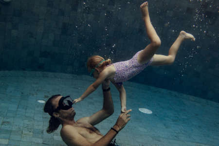 father and daughter swimmingの写真素材