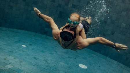 father and daughter swimming