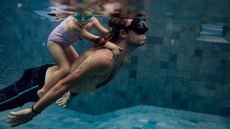 father and daughter swimmingの写真素材