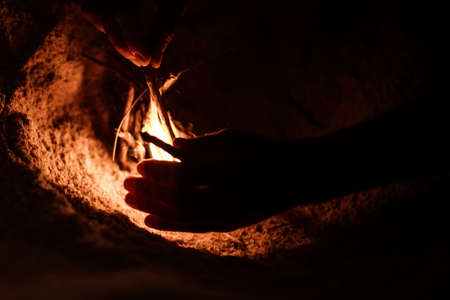 tourist makes a fire on the beachの写真素材
