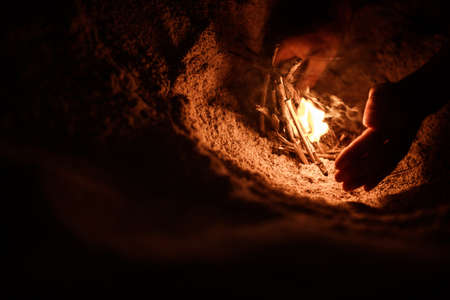 tourist makes a fire on the beachの写真素材