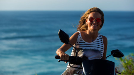 portrait of a beautiful girl driving a motorcycle