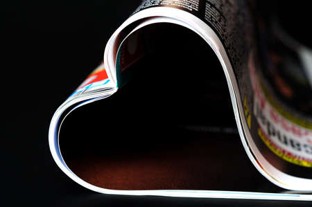 Magazine in heart shape on blackの写真素材