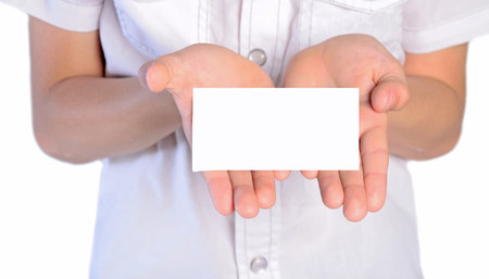 closeup of young boy holding note in palmの写真素材