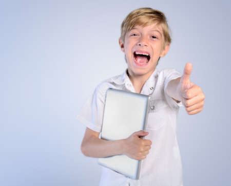 Young boy with tablet agreeの写真素材
