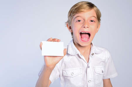 young boy holding note and screamingの写真素材