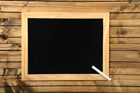 blank chalkboard on wood backgroundの写真素材