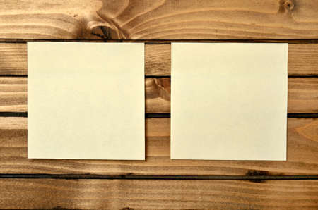 twp blank postnote on wood backgroundの写真素材