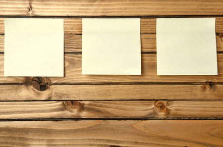three blank postnote on wood background