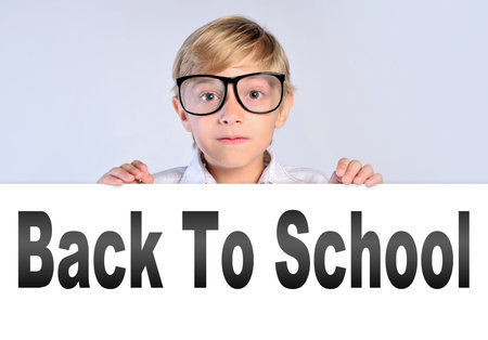 Young nerd boy leaning on bannerの写真素材