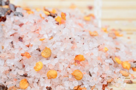 pink salt with chili seed on wooden tableの写真素材