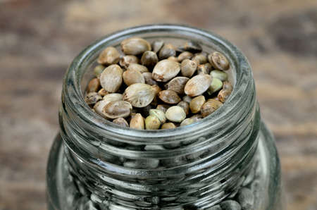 hemp seed in jar on wooden tableの写真素材