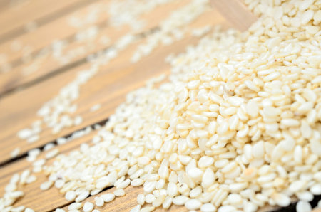 white sesame on wooden tableの写真素材