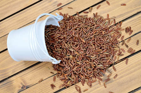 red rice on wooden tableの写真素材