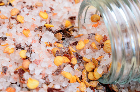pink salt with chili seed on wooden table