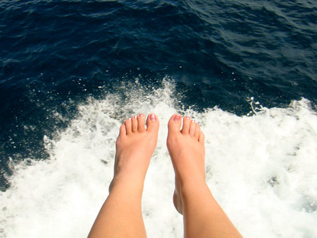 Feet hang from a boat