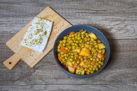 Fresh green peas with tomato sauce potatoes and carrot Greek foodの写真素材