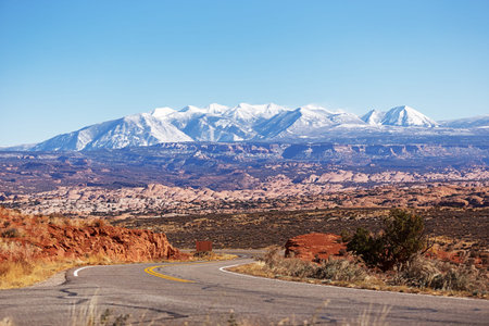 Winding road in a park Arches in Utah US plateau Park arches and views of Mount Waas.の写真素材