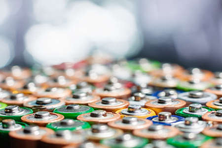 Energy abstract background of colorful batteries. Close up top view on rows of selection of AA batteries. Alkaline battery aa size. Several batteries are next to each other. Many aa batteries.の写真素材