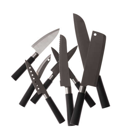 Many kitchen knives for fish meat cheese bread fruits with black handles on white backgroundの写真素材