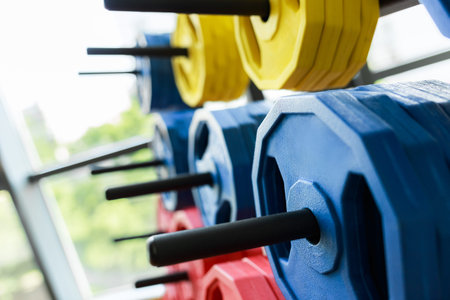 A lot of colorful dumbbell on stand
