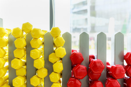 A lot of colorful dumbbell on stand