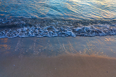 Wave on the sea sandy shore (Detail, close-up)