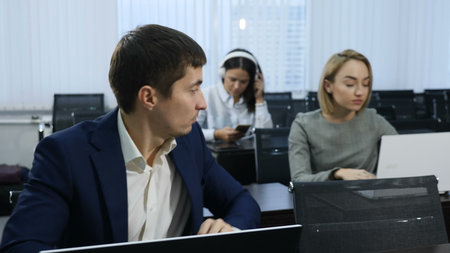 Business and office life concept. Group of coworkers sit in auditorium, lecture hall. Shot in 4 k