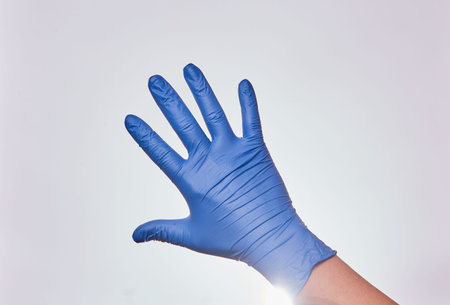 Man's hand with nitrile gloves for medicine isolated on white background.