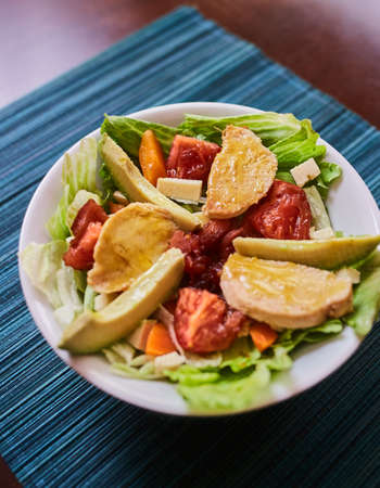 lettuce salad with chicken, tomato, cheese, avocado, carrot and honey mustardの写真素材
