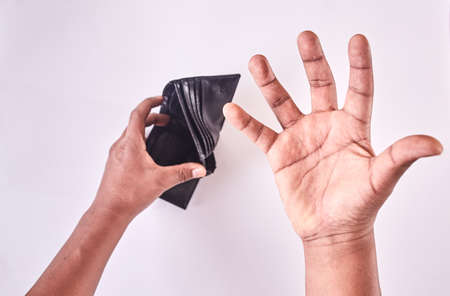 Man hands looking for money in wallet. Wallet without money. Isolated on white backgroundの写真素材